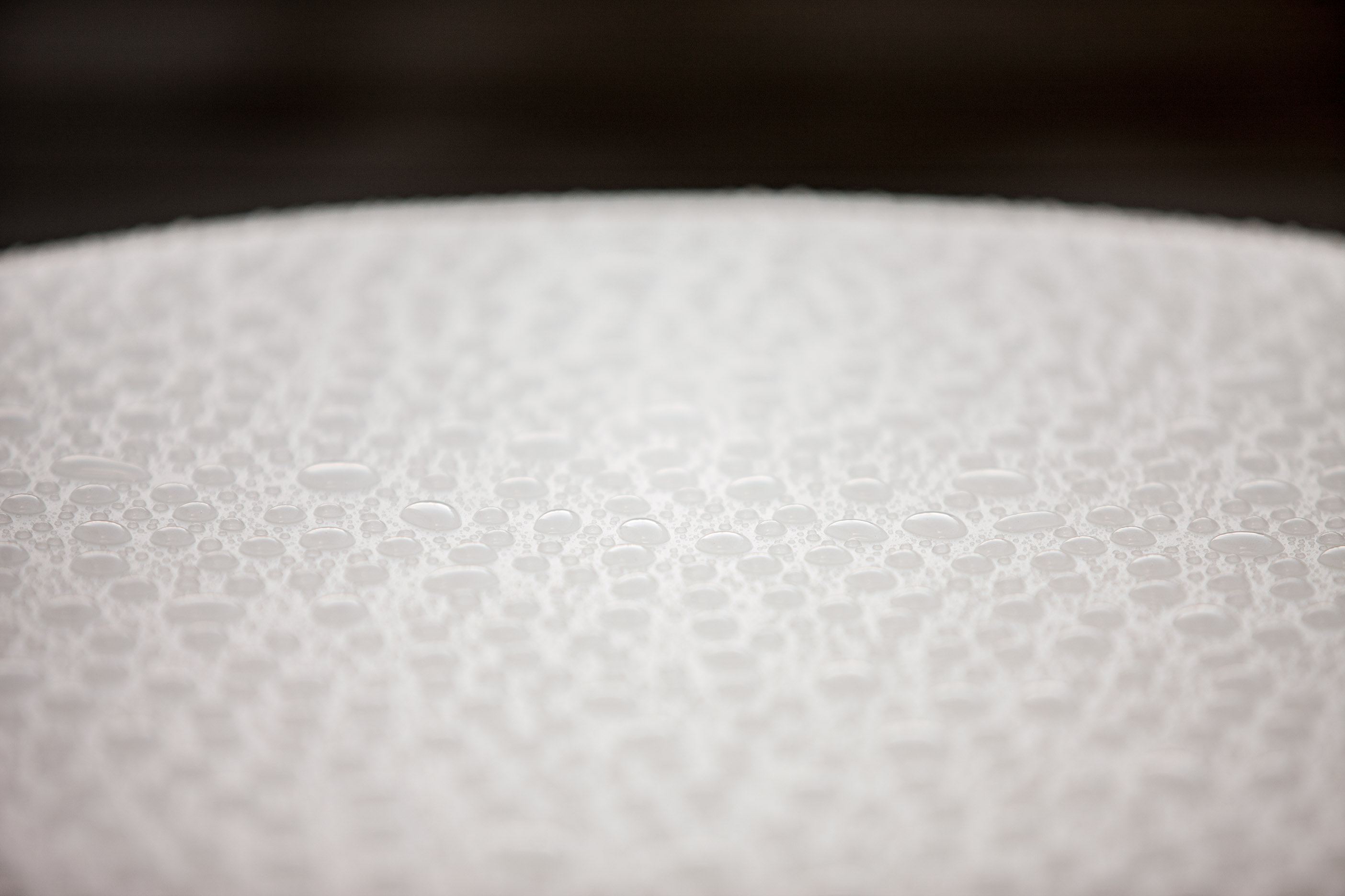 A macro frame of a galvanised steel surface, spangled where the zinc has crystallised.