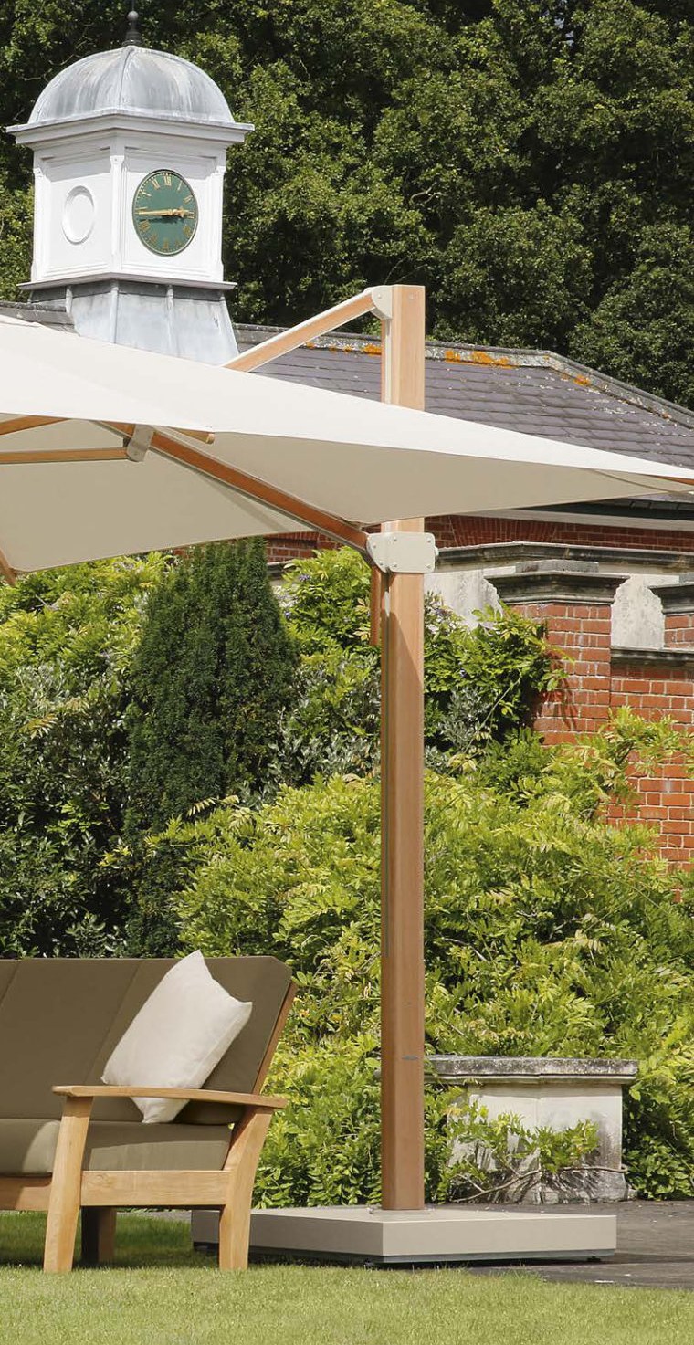 Napoli cantilever parasol shading a teak lounger in a walled garden